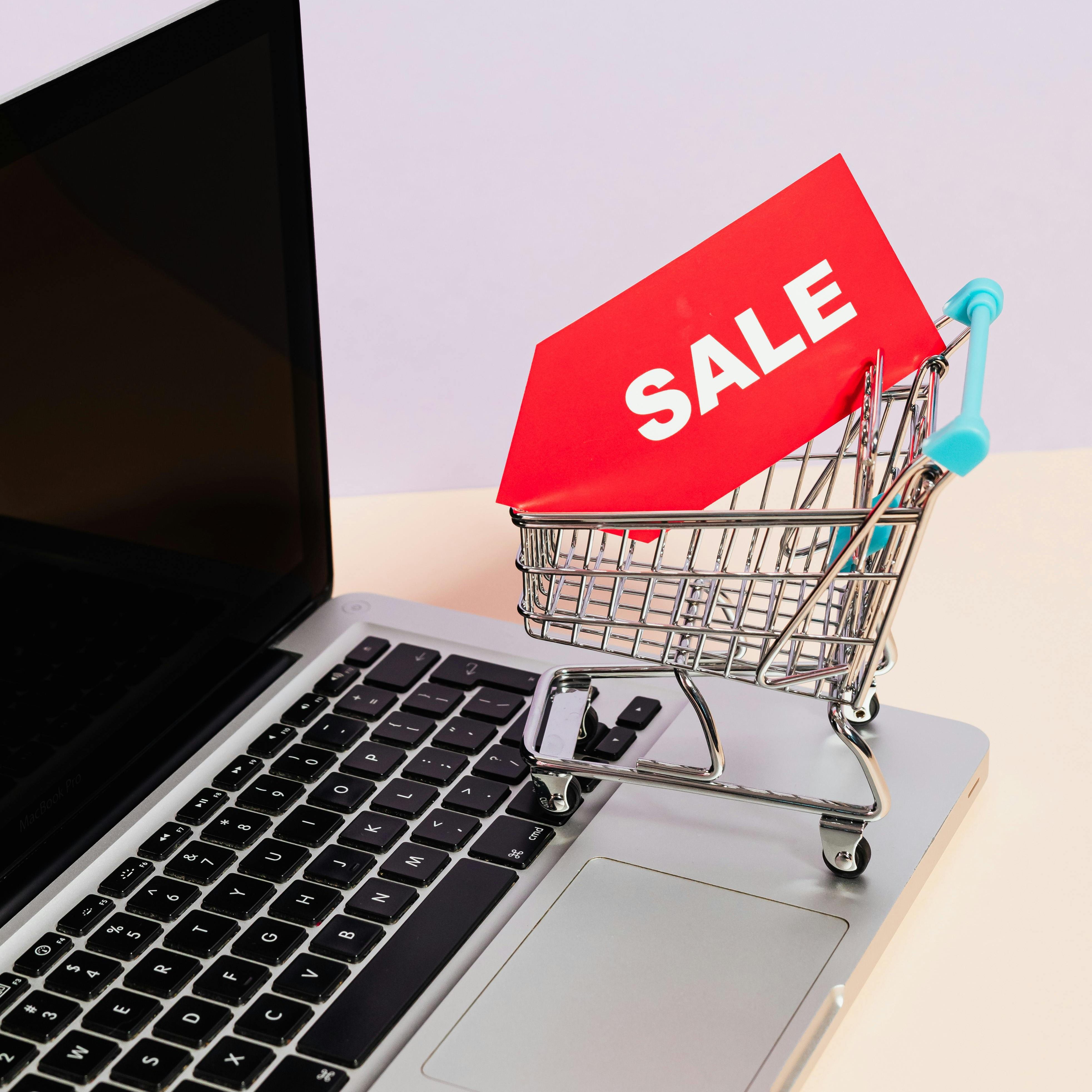 Photo of a mini shopping cart on a laptop to represent an online shopping button for toilet partitions from Partition Plus