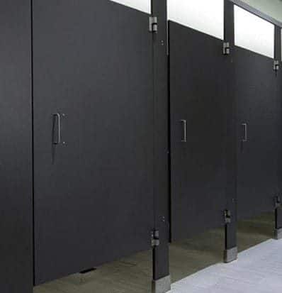 Black high pressure laminate toilet partitions in a commercial restroom
