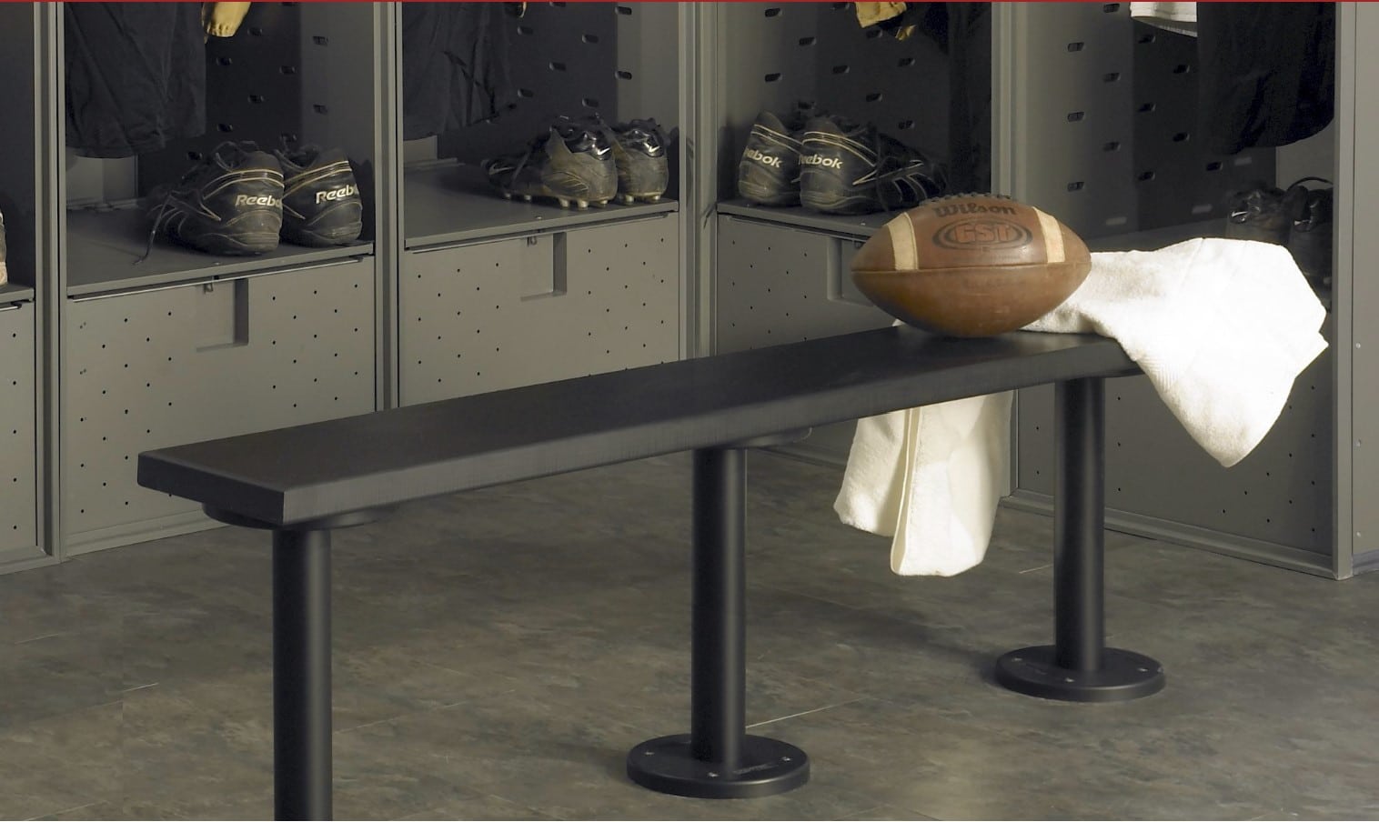 Black locker room bench with a football