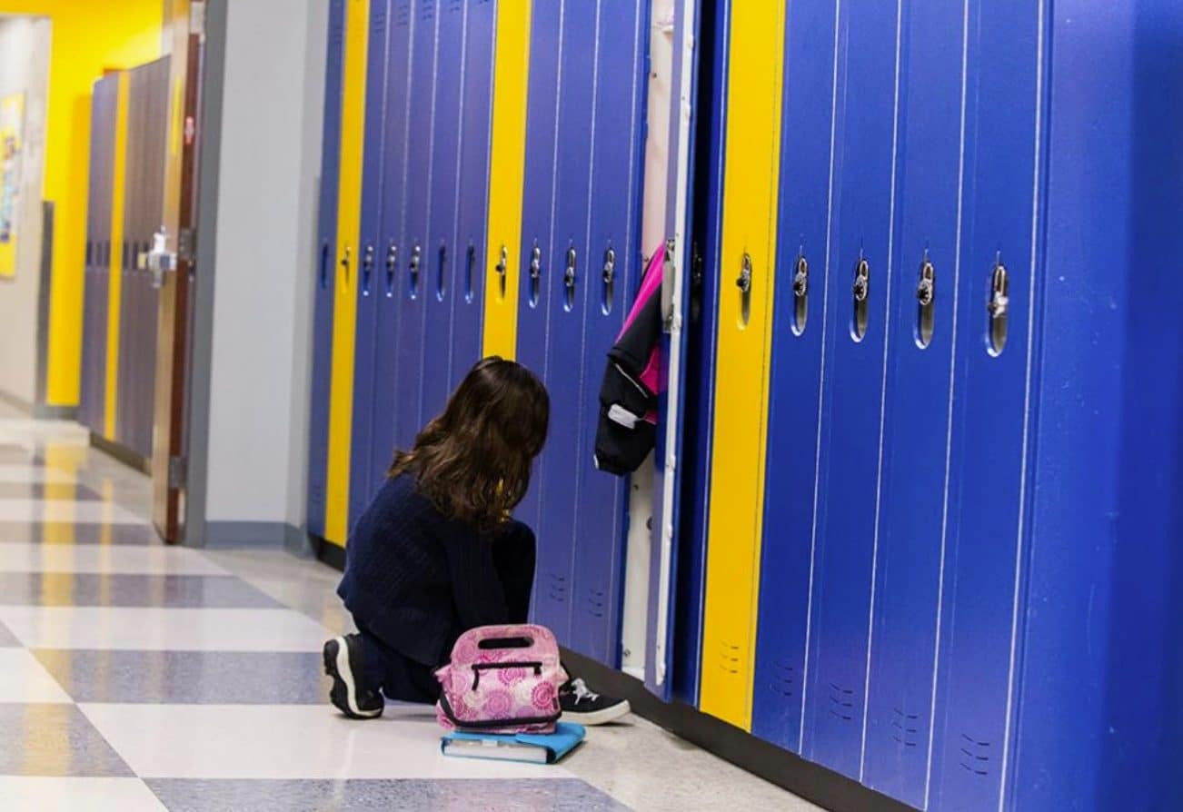 Blue and yellow lockers in a school hallway