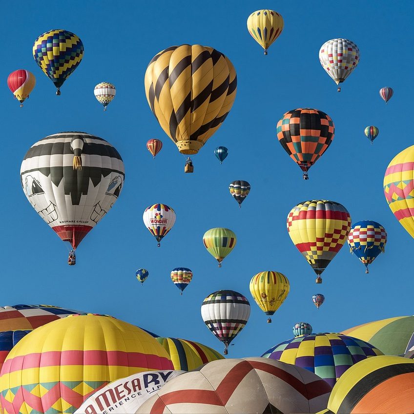 Hot air balloon rise above the landscape of Albuquerque, New Mexico. Partition Plus rises above as the top source for bathroom partitions in Albuquerque, New Mexico. Photograph of multicolored hot air balloons in Albuquerque, New Mexico.
