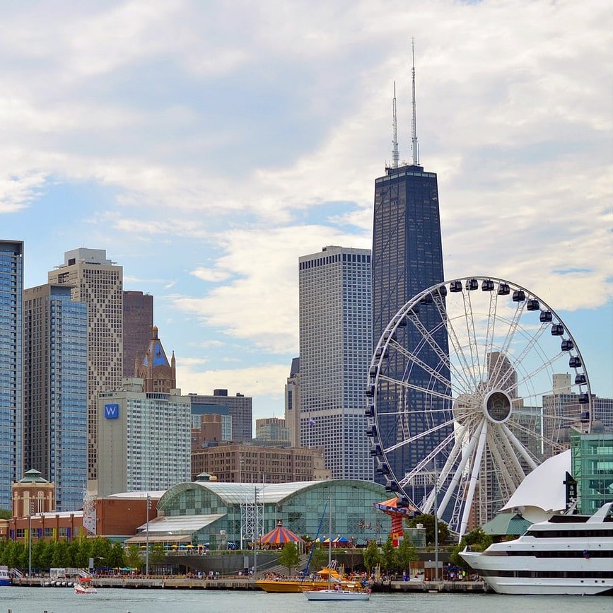 Photograph of Chicago skyline with clouds near water during daytime.