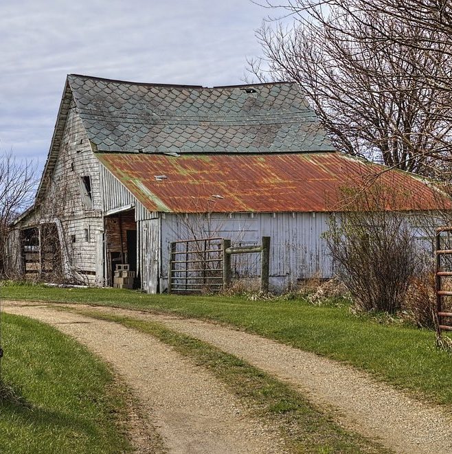 Charming, rustic structures dot the Ohio countryside. Buy bathroom stalls from Partition Plus in Columbus, Ohio to keep restrooms looking fresh, not rustic. Photograph of old barn and dirt road in Ohio countryside.