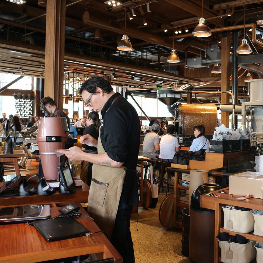 Seattle coffee shops are known for their comfortable atmosphere. Turn to Partition Plus to increase the comfort of your restroom. We sell bathroom stalls in Seattle, Washington. Photograph of a male barista preparing coffee in Seattle, Washington.