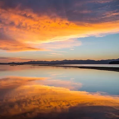 Bathroom partitions in Billings, Montana are offered in a rainbow of colors from Partition Plus. Sunrise over lake in Montana, clouds of yellow, orange, pink.