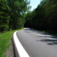 Photo of a road with streaking showing speed.